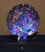Lighted Saw Blade Sculpture Showing Different Colored Reflections
